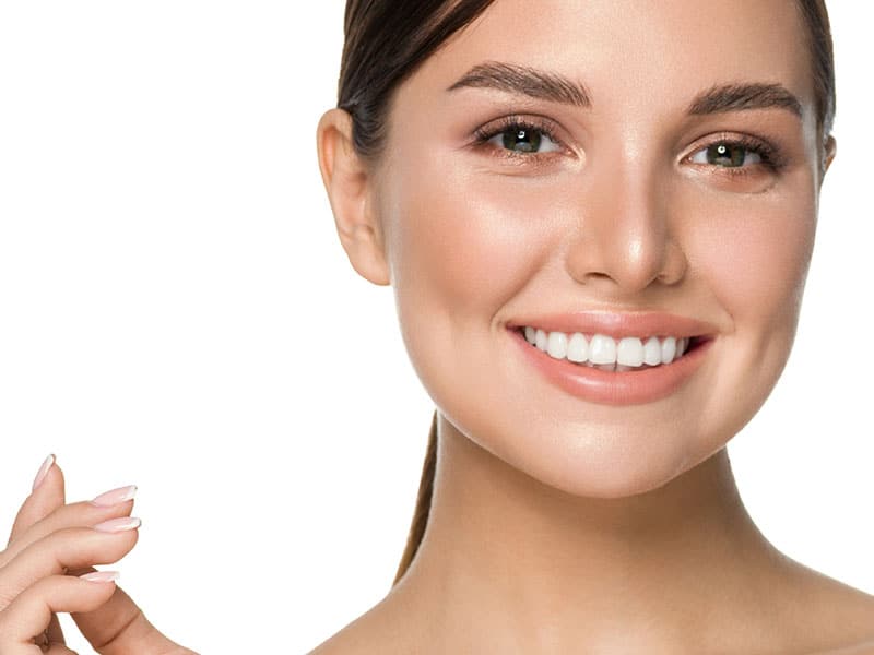 Radiant woman smiling after teeth whitening
