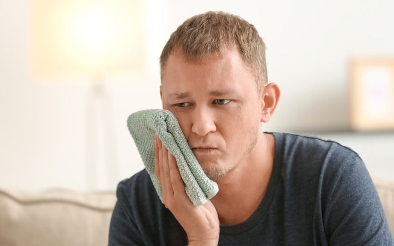 man suffering toothache home