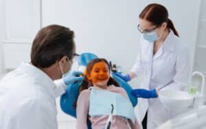 funny patient kid smiling and looking through orange protection